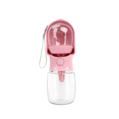 Pink VitalGroom portable pet hydration and treat bottle with clear reservoir, integrated trough, and wrist strap
