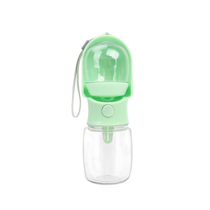 Green VitalGroom portable pet hydration and treat bottle with clear reservoir, integrated trough, and wrist strap